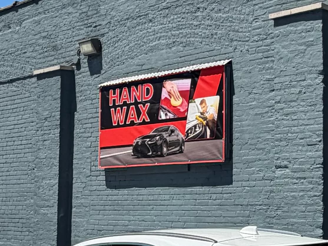 The Hand Wax service banner on the wall at 1701 S. State St.