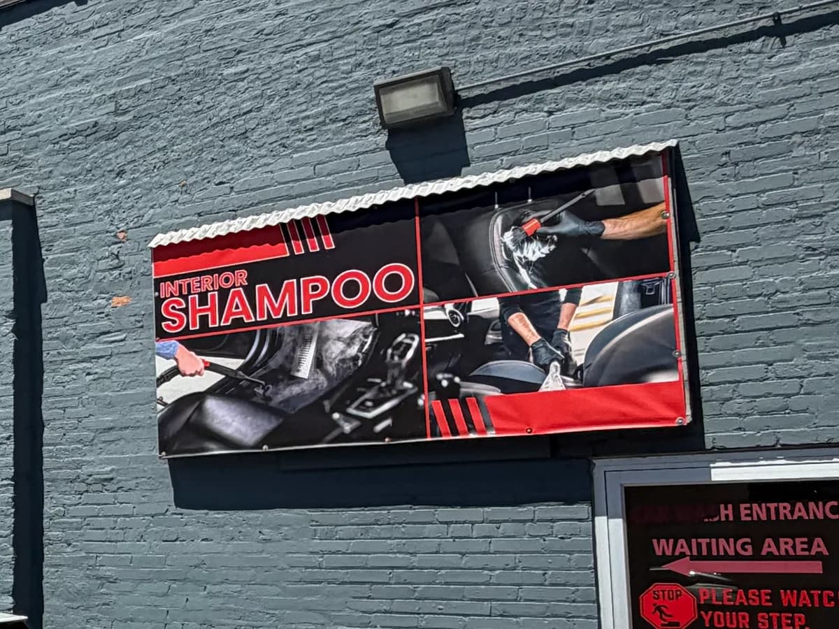 The Interior Shampoo service banner on the wall at 1701 S. State St.